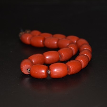 Strand with antique tibetan sherpa coral resin beads