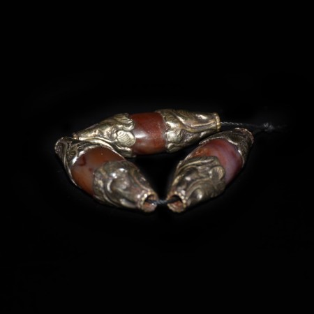 Three old large silver repoussee capped Carnelian Beads