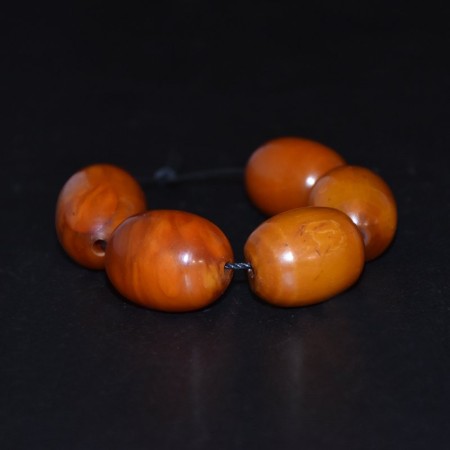 Five antique butterscotch simulated Amber / Faturan Beads