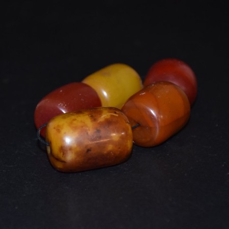 Five huge massive antique simulated Amber Beads