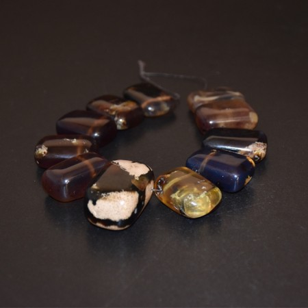 Strand with eleven large natural amber pendants