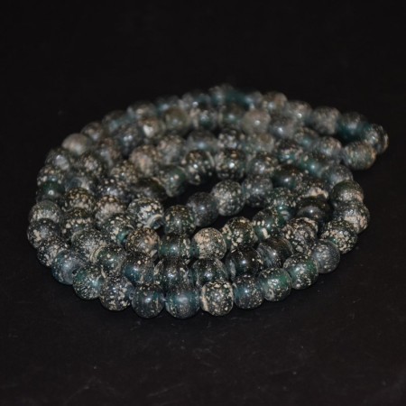 Long strand with antique green-blue islamic glass beads