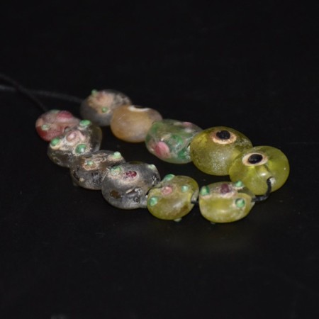 Strand with eleven antique islamic eye glass beads