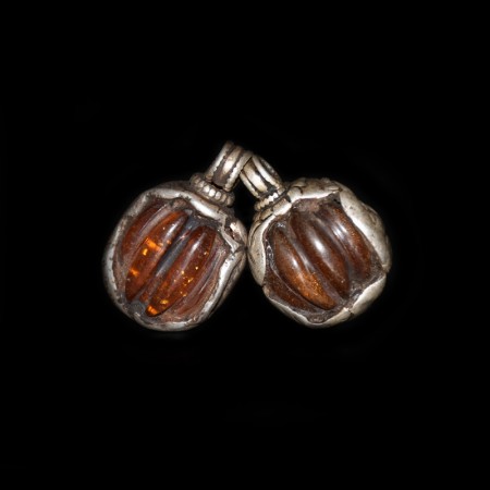Two antique tibetan simulated Amber Silver Repoussee Pendants