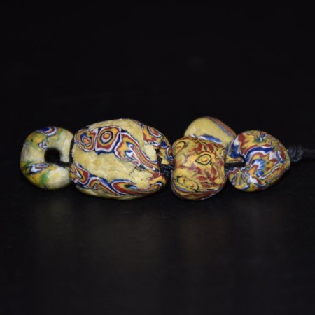 Five yellow antique venetian glass beads