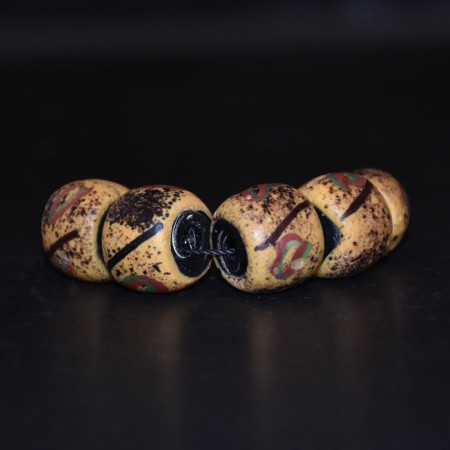 Five large antique venetian yellow black core glass beads