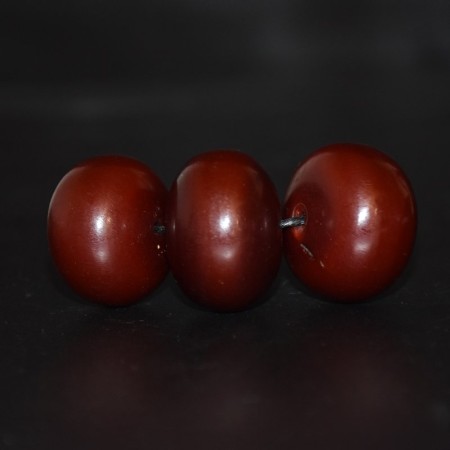 Three large antique cherry colored Bakelite / Simulated Amber Beads