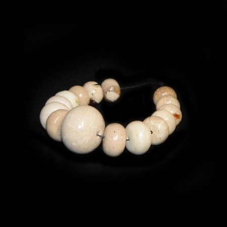 String with graduated white Amber Beads